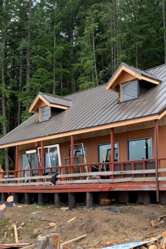 Premium architectural standing seam metal roofing installed to protect against heavy tree canopy debris.