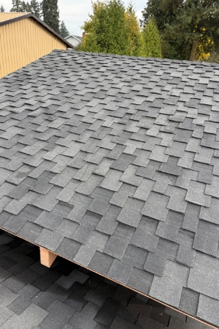 Section of a residential roof featuring newly laid GAF Timberline HDZ shingles in the historic Willamette area.