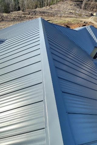 Clean lines of a commercial grade standing seam metal roof installation on a property near the Carver area