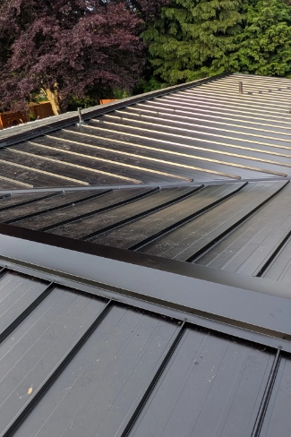 Finished commercial grade standing seam metal roof installation on a historic structure near Canemah