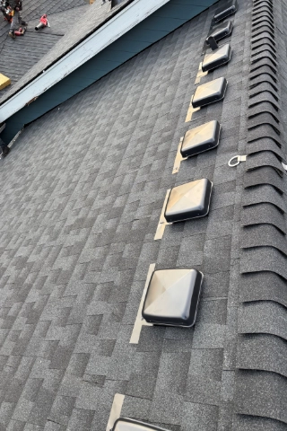 Close up view of a newly completed architectural shingle roof replacement on a residential home in the Robinwood neighborhood.